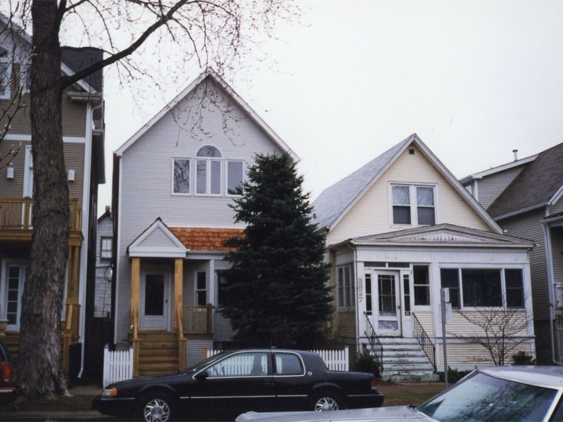 Street view of a renovated home between neighboring houses